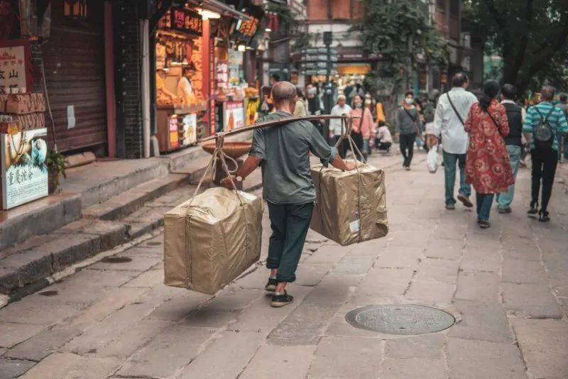 他们穿梭在城市的街头巷尾,背负起生活的重担.