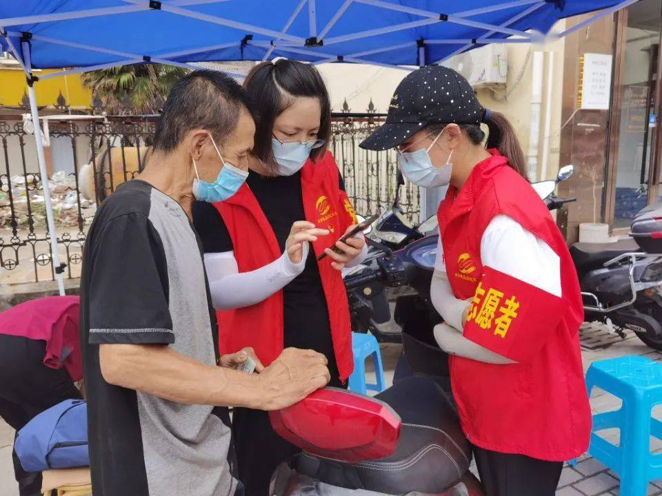 李丽萍(右一)从早上9点至下午6:30,虽然外面是最高达到32度的高温,穿