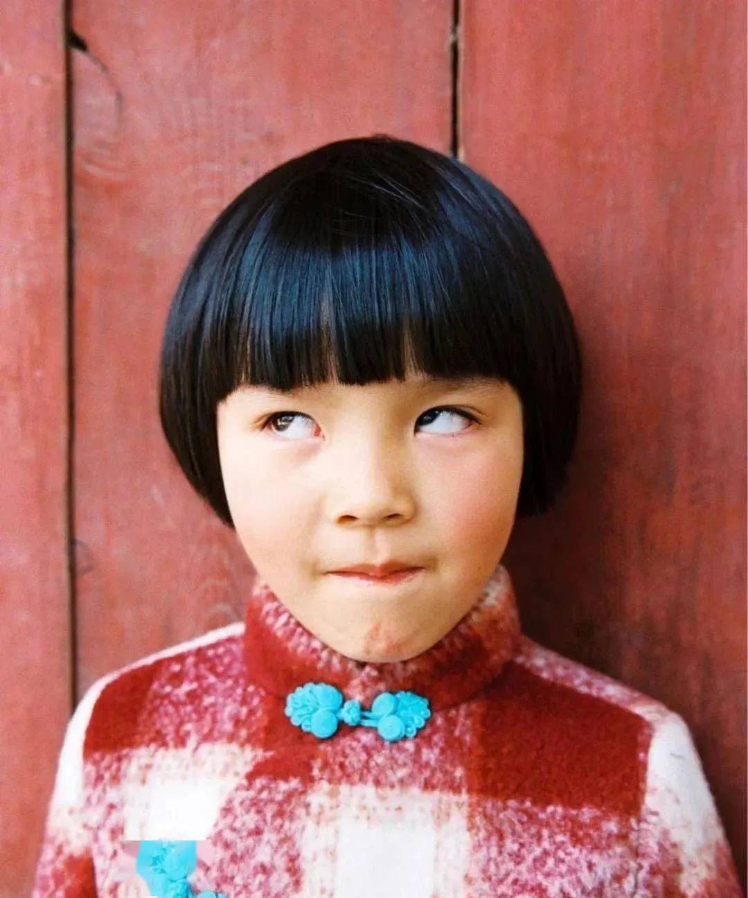 一个齐刘海的小女孩,对着镜头翻起了白眼.