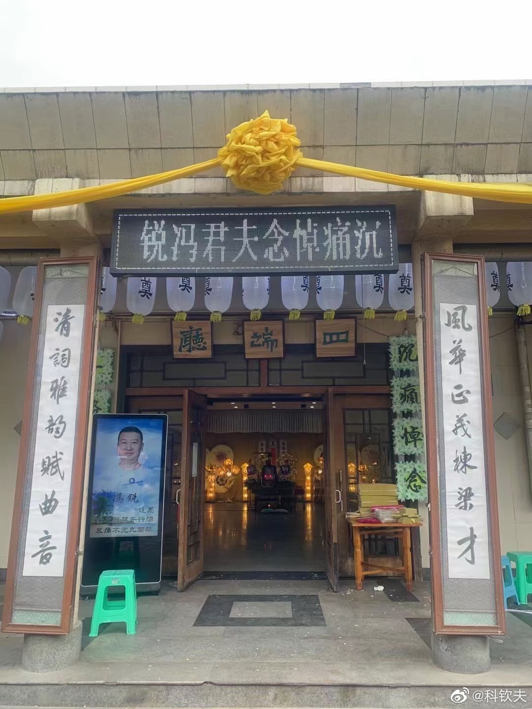 一张家属为逝者设立的灵堂照,门匾黑底白字写着"沉痛悼念夫君冯锐"