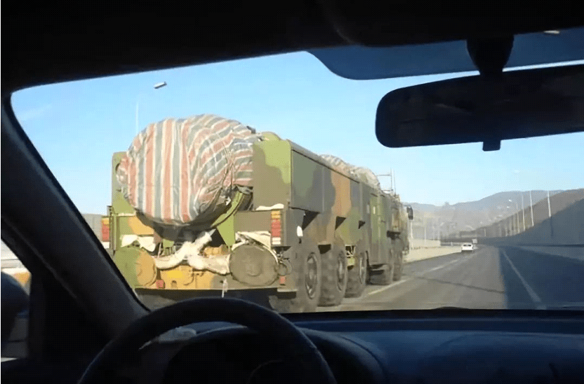 比如,有可能是一辆十轴运输车,上面拉的是出口创汇产品"大胸径原木".