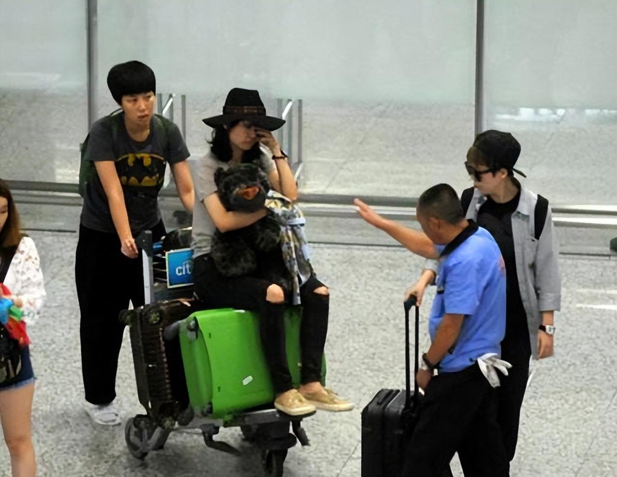 李小璐现身酒吧拍策划,留大波浪穿短裙秀美腿,助理蹲地帮忙穿鞋_明星