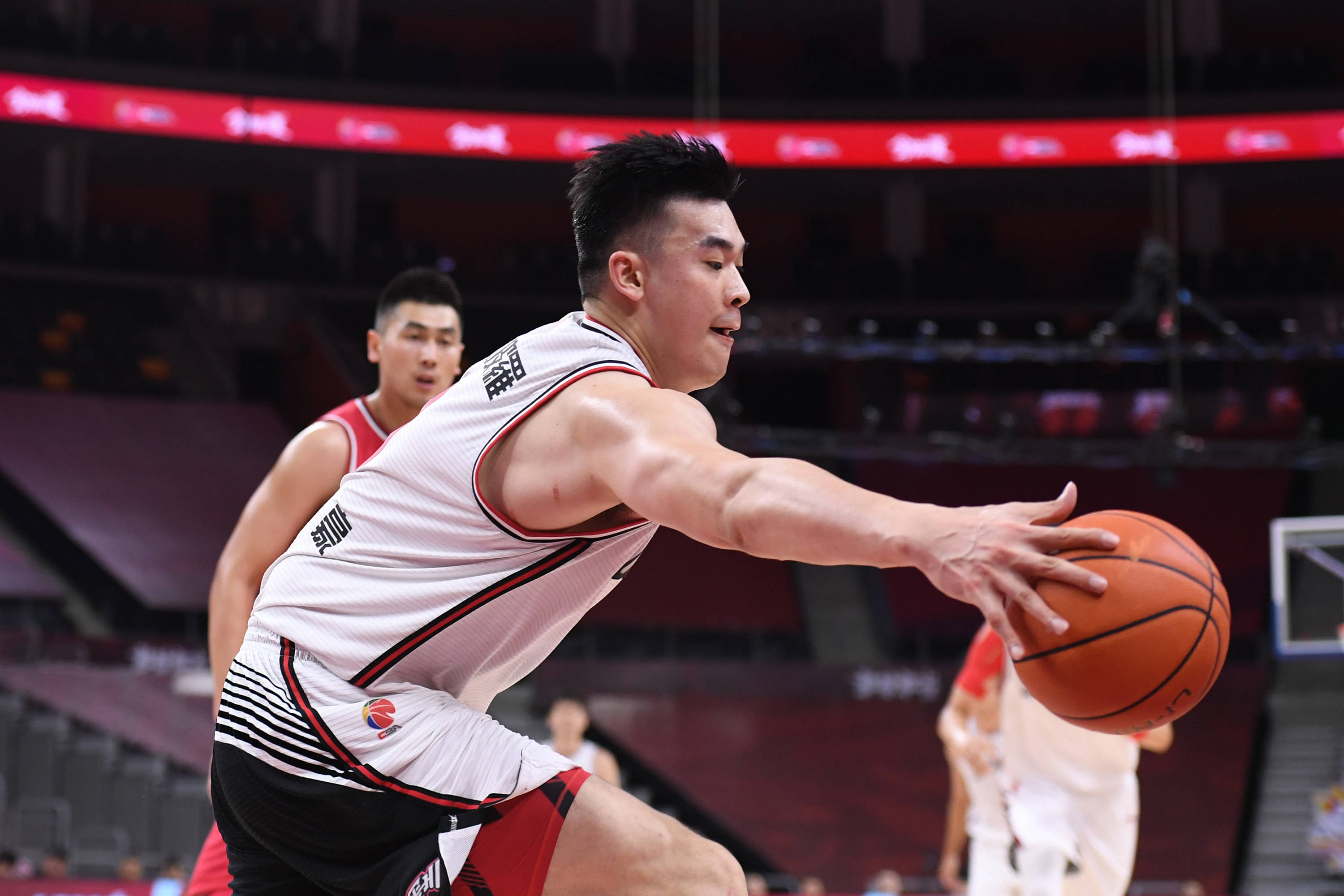 6月25日,深圳马可波罗队球员李慕豪(前)在比赛中救球.