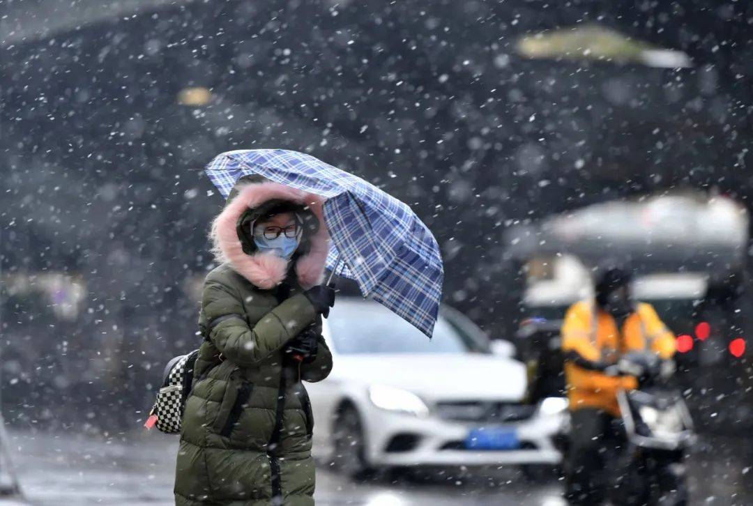 12月29日下午,汉口城区风雪骤然加大,解放大道航空路,路人在风雪中