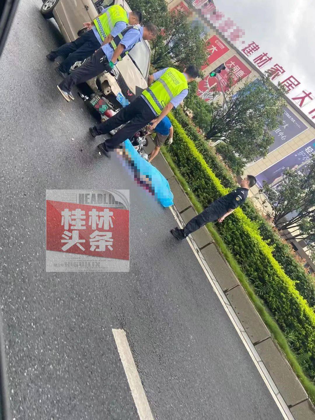 现场桂林西二环突发车祸有人被盖上蓝布