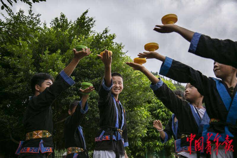 6月25日,贵州省荔波县瑶山民族小学,孩子们在玩陀螺.