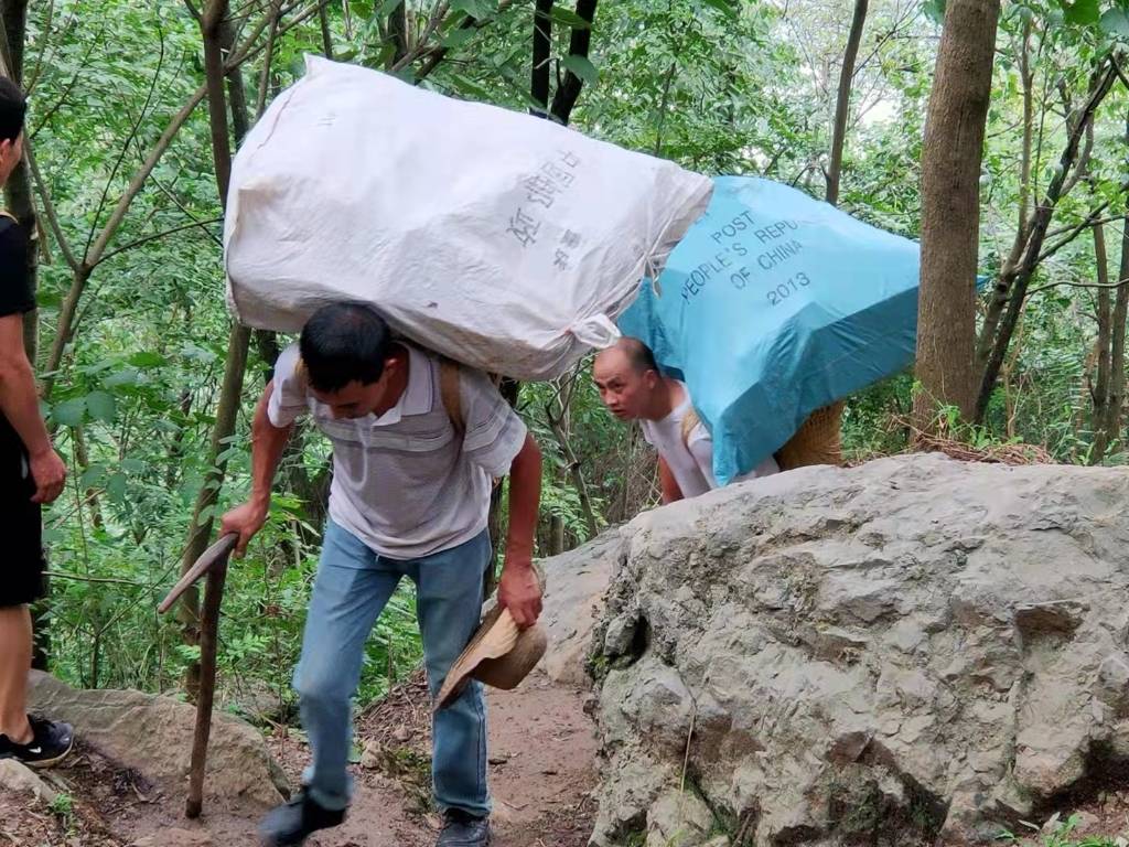 滑坡 塌方!邮政小哥"蚂蚁搬家"背5000件包裹翻过大山