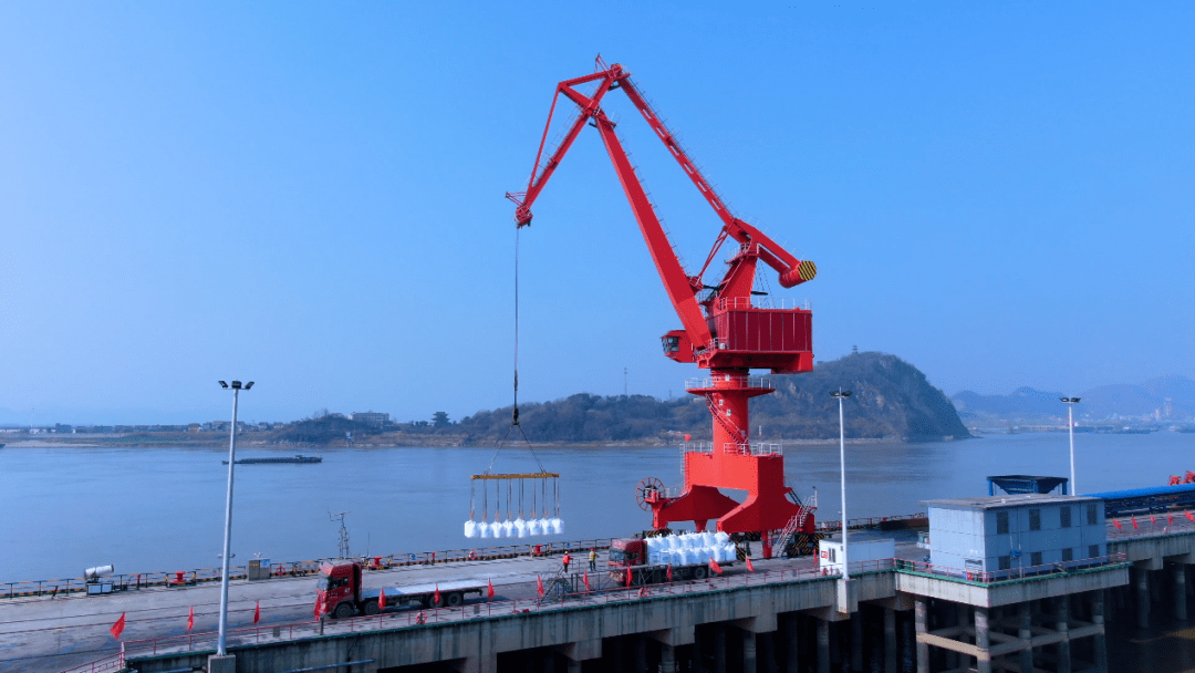 在祥云股份现代化的高桩综合码头,巨型的吊机与装卸工人熟练配合,一次