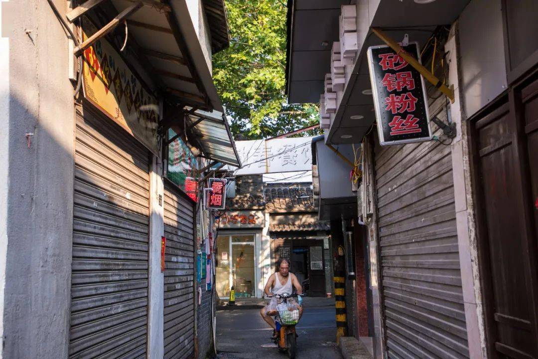 从渡江路拐进苏唱街清晨的光照亮了灰色的青石板路在屋前纳凉的老夫妻