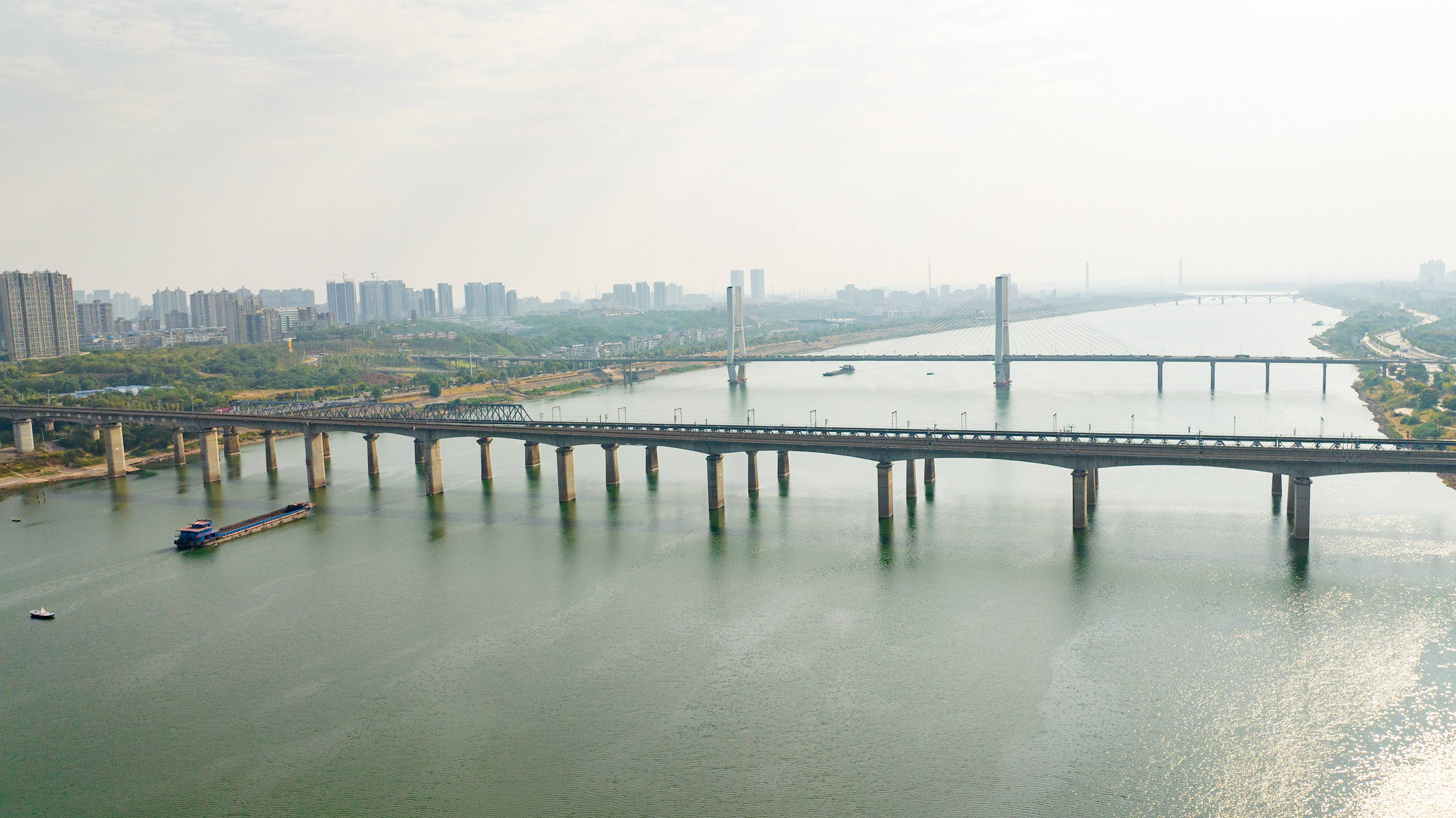 在湘江北岸的沿江路上,江中水滔滔,岸上绿如荫,左右两侧的湘潭三大桥