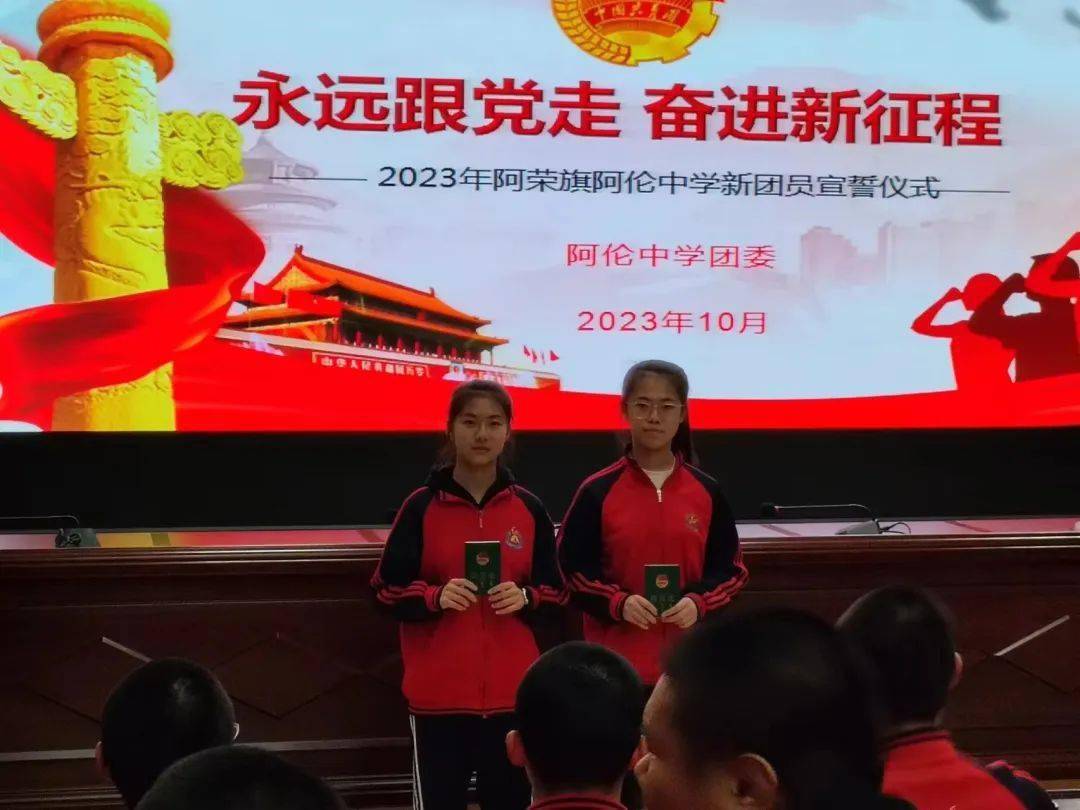 阿荣旗阿伦中学团委书记王金香和老团员一起为新团员代表颁发团员证